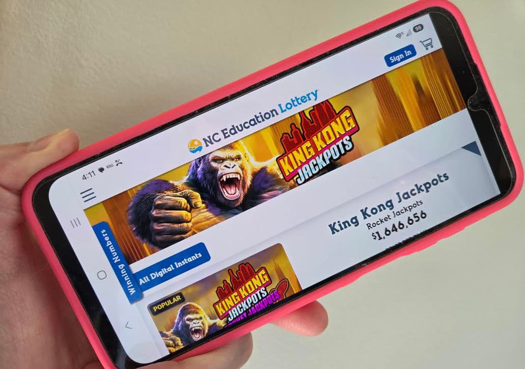 A phone displays North Carolina Education Lottery digital instant games.